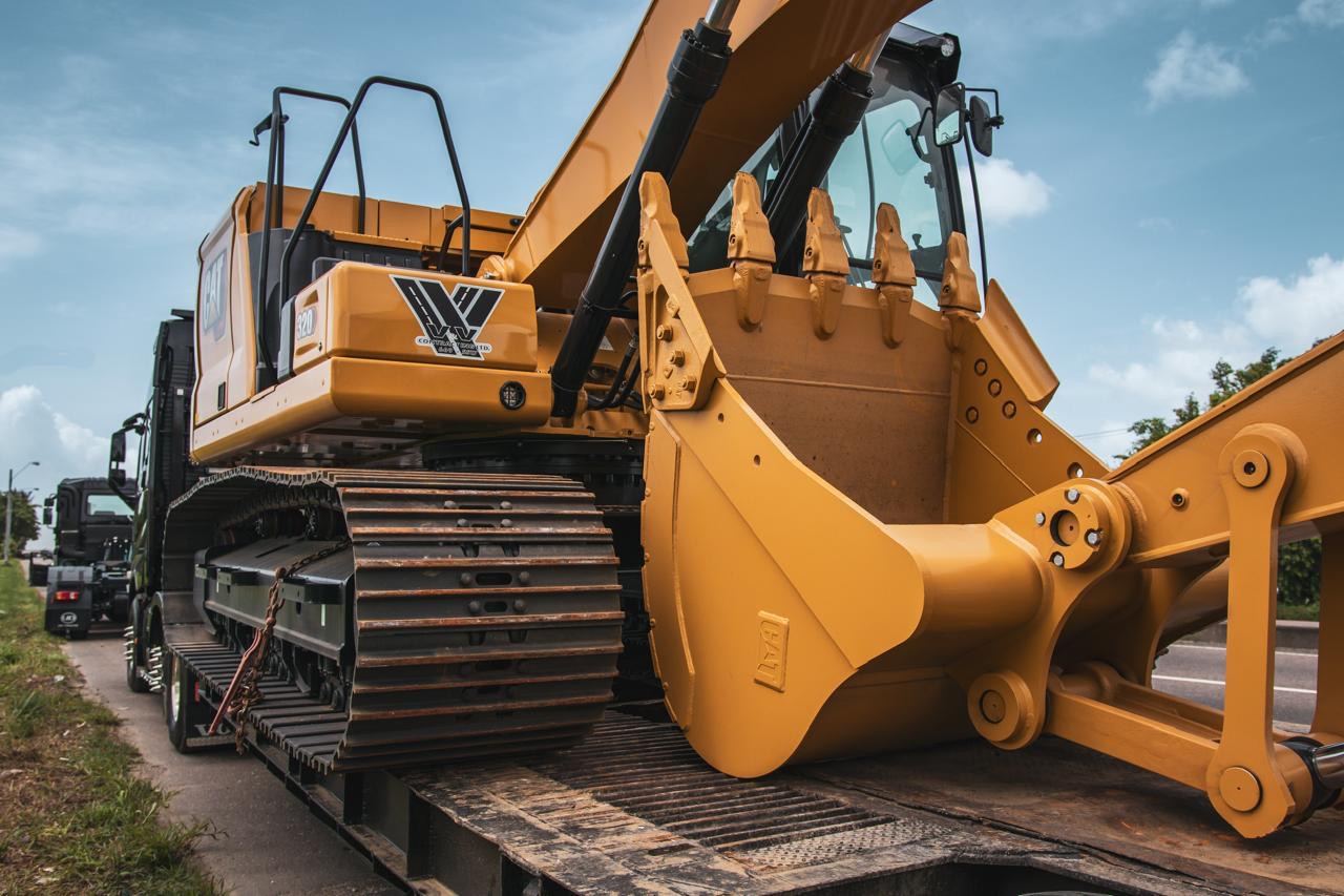Cat 320 excavator loaded on a low loader