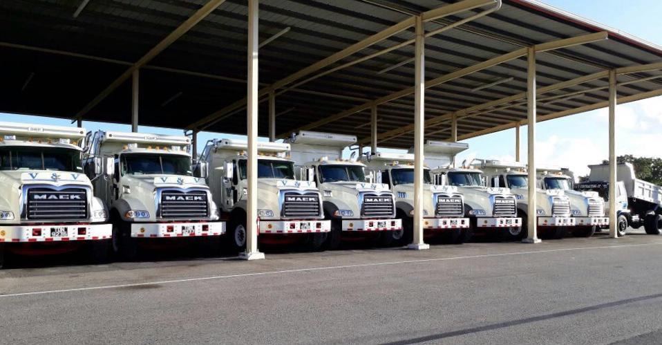 Row of Mack tippers under the covered yard